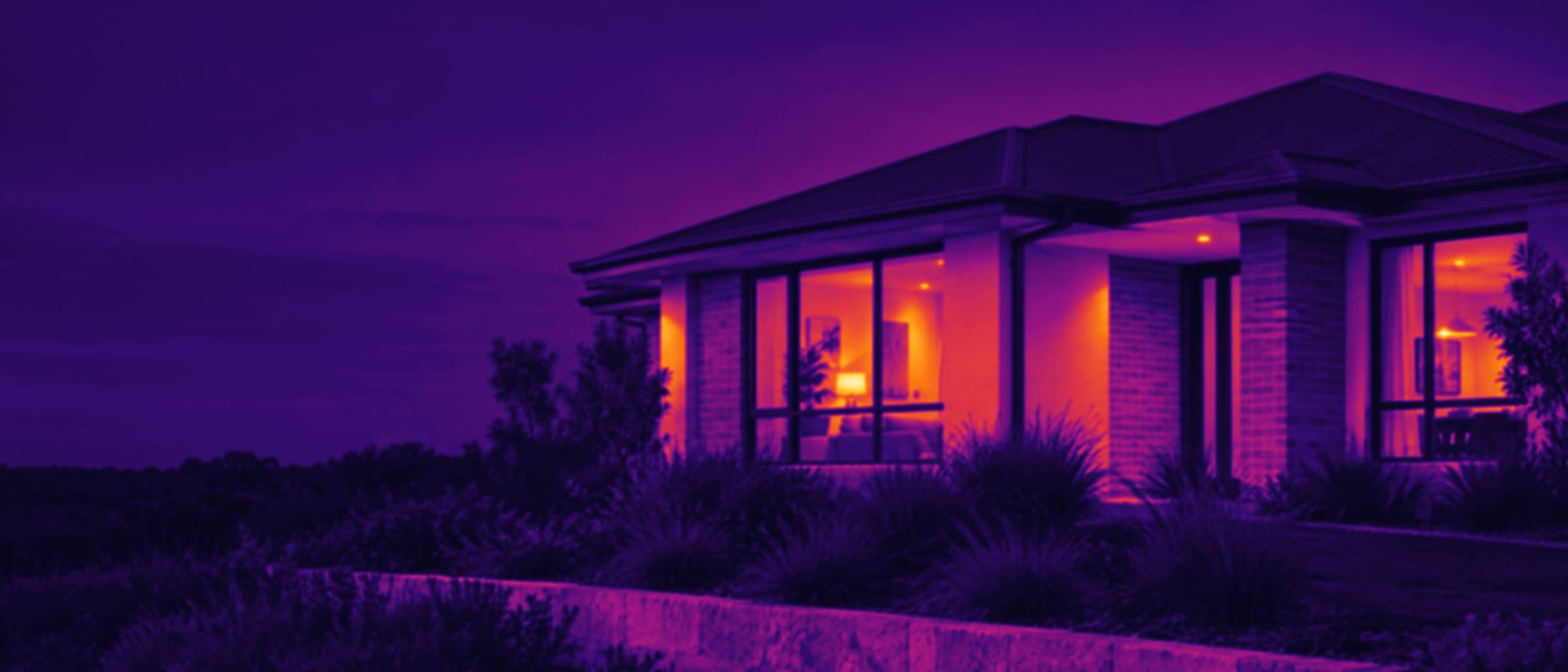 Thermal rendering of the same home: warm glazing and interior against a cold evening sky